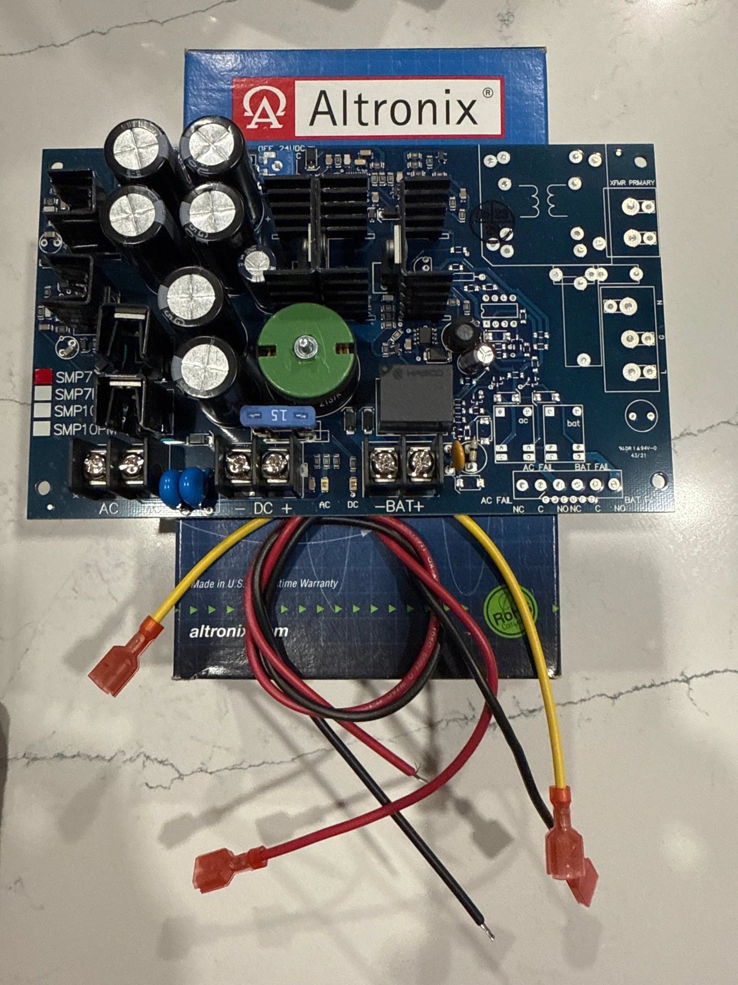 Altronix SMP7 power supply and charger with selectable 6VDC, 12VDC, or 24VDC output and 6-amp capacity, providing reliable power for access control, fire alarm, and security systems.